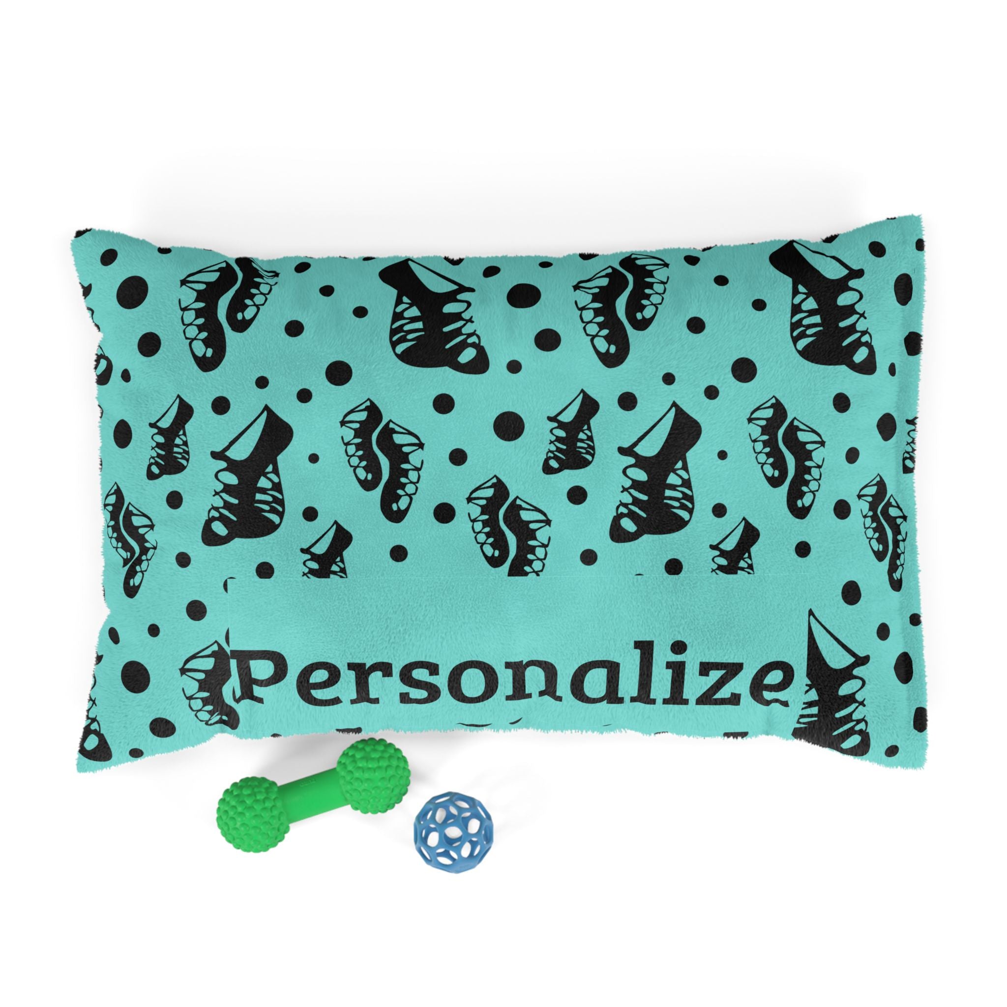 Irish dance pet bed with black ghillie soft shoe print on turquoise, shown with dog toys
