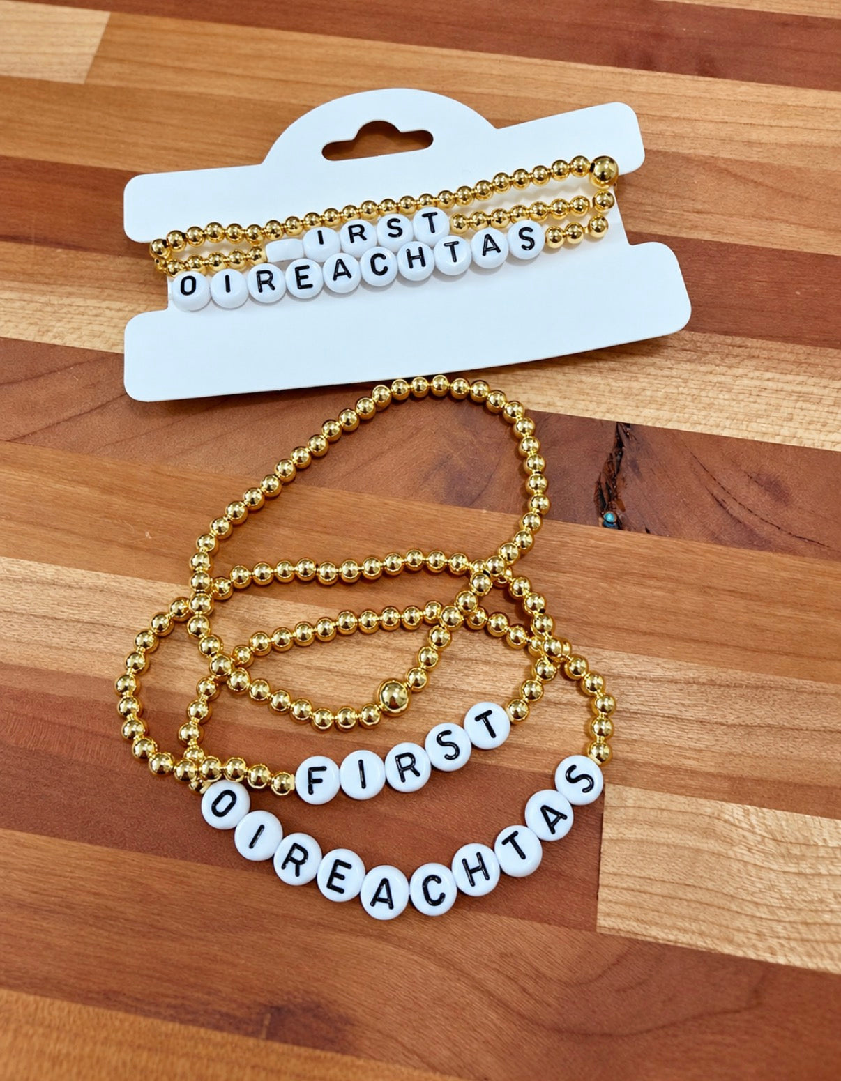 First Oireachtas Bundle: First, Oireachtas and plain gold bead stacking bracelets on a gift card