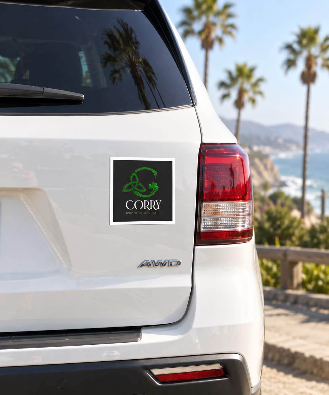 A square black decal with a green coconut shell logo and the word 'CARRY' is applied to the rear left side of a white SUV, with a coastal beach and palm trees blurred in the background.