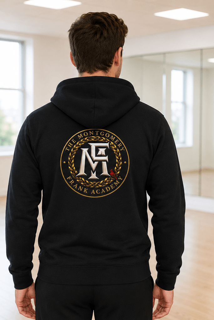 A man modeling a black zip-up hoodie in a bright indoor studio, shown from both the front and back. The front has a small circular crest on the left chest and the name 'Ethan' on the right chest.