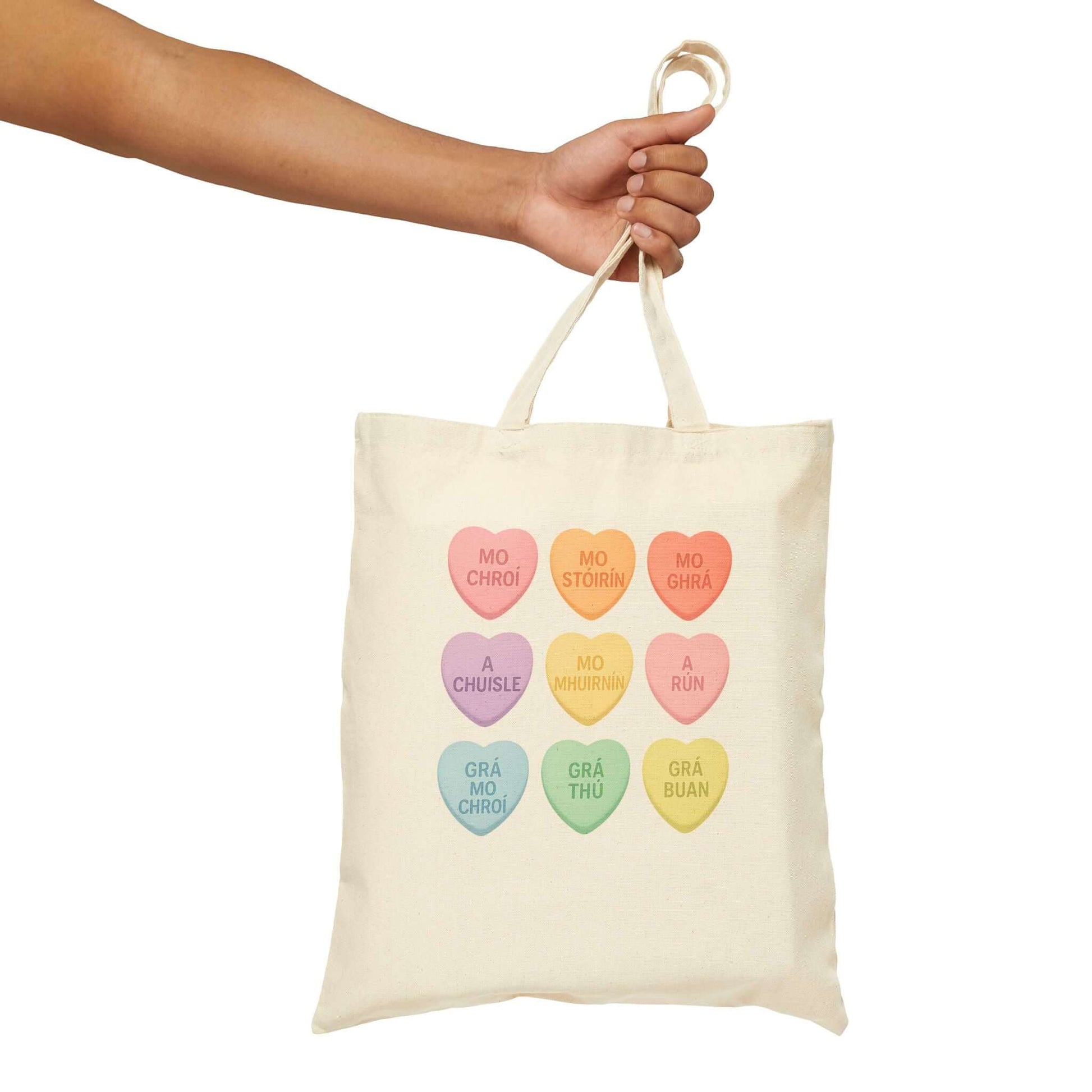 Gaelic conversation hearts tote bag on pink background

Irish love phrases canvas tote bag flat lay

Natural canvas tote with Gaelic Valentine hearts

Irish language tote bag with pastel hearts