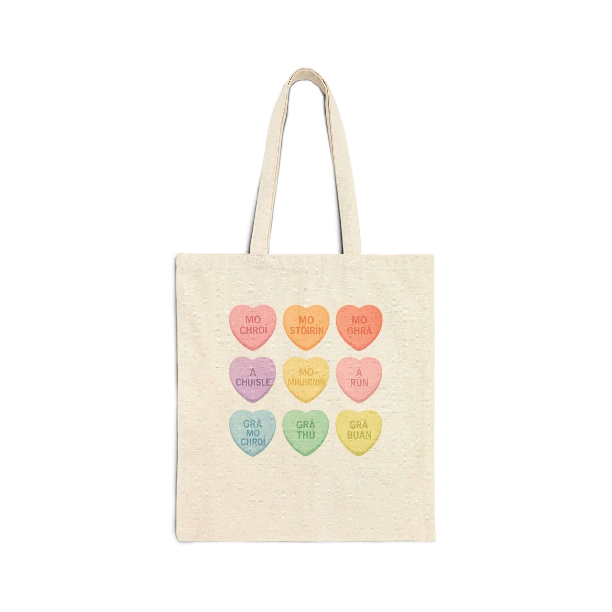 Gaelic conversation hearts tote bag on pink background

Irish love phrases canvas tote bag flat lay

Natural canvas tote with Gaelic Valentine hearts

Irish language tote bag with pastel hearts