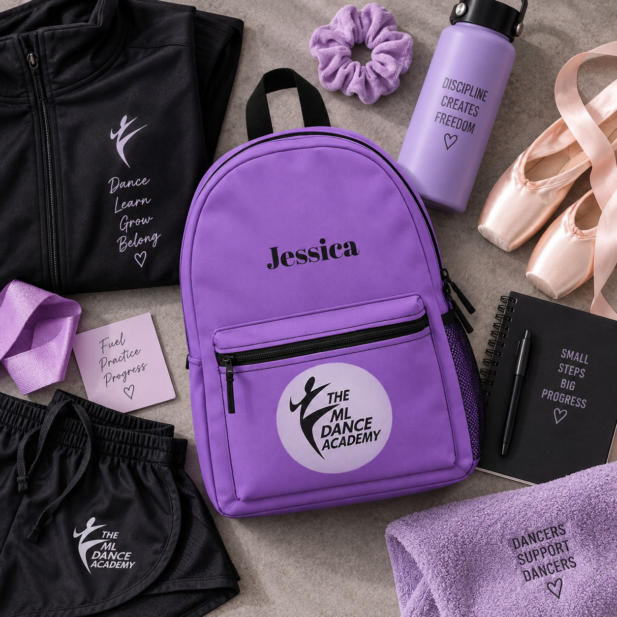 A styled flat-lay of dance apparel and accessories around a personalized purple backpack. The central product is a lavender-purple backpack with black zippers, black handles, and a white circular logo patch reading 'The ML Dance Academy' with the name 'Jessica' printed above it.