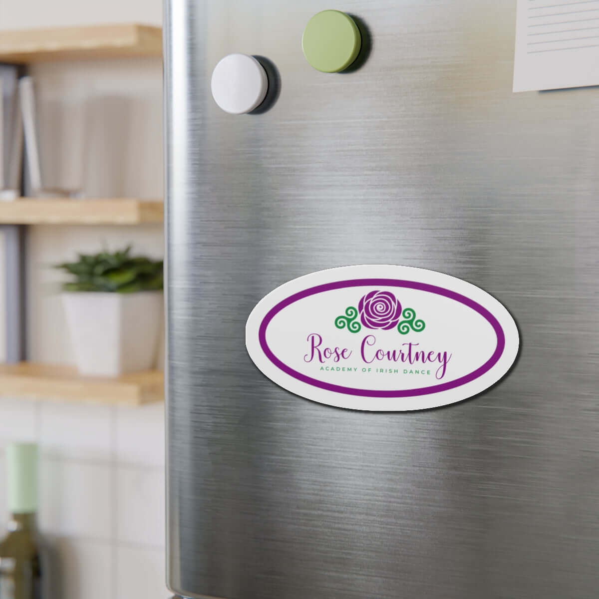Rose Courtney die-cut custom magnet on stainless steel fridge in modern kitchen.