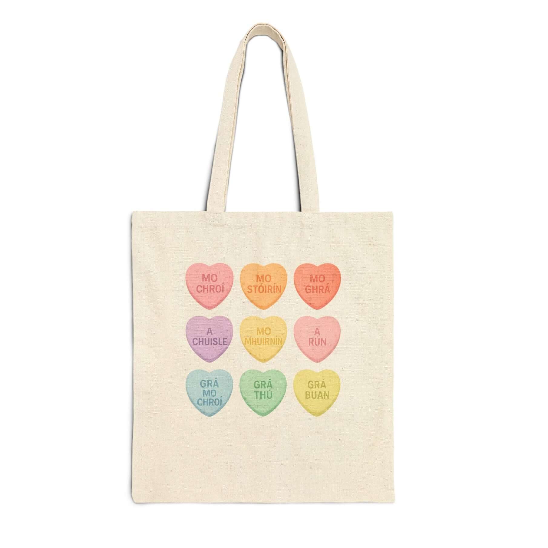 Gaelic conversation hearts tote bag on pink background

Irish love phrases canvas tote bag flat lay

Natural canvas tote with Gaelic Valentine hearts

Irish language tote bag with pastel hearts