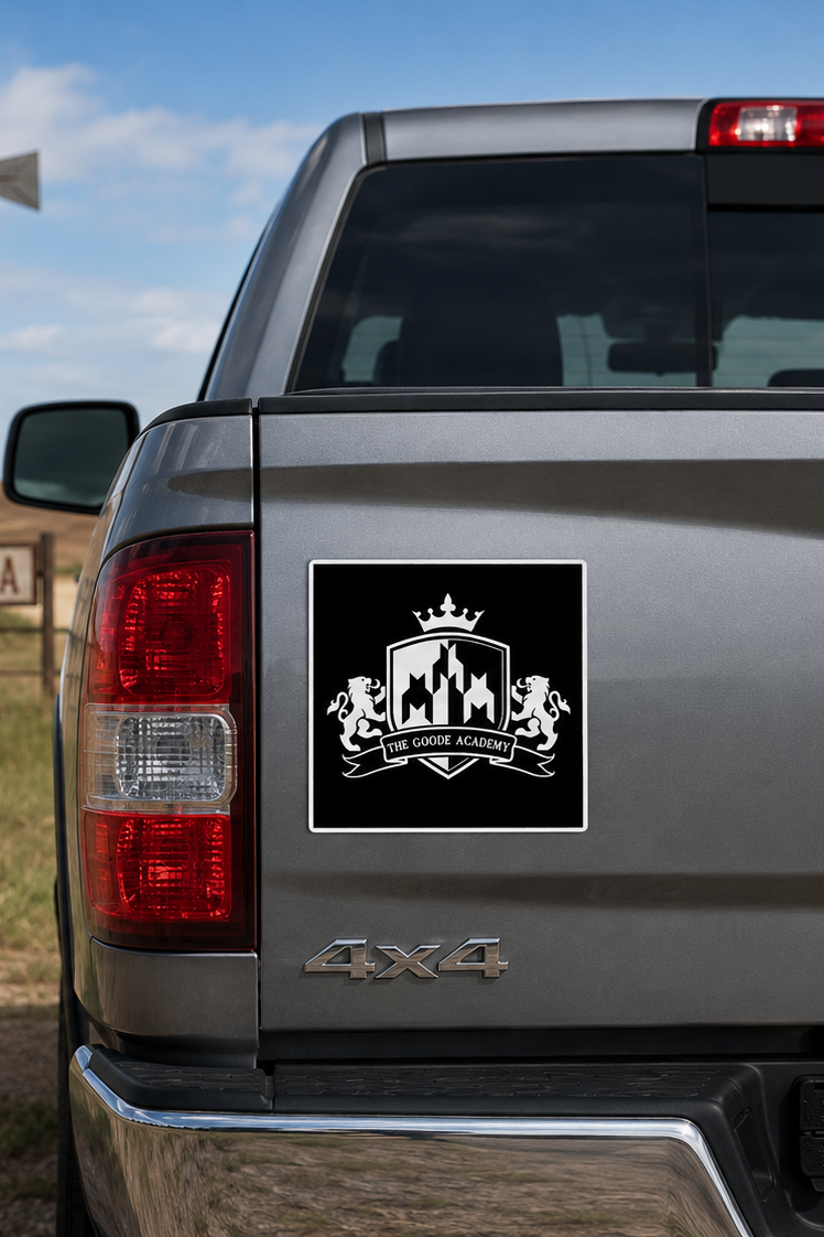 A black and white crest-style decal with a crown and lions is shown applied to the rear left side of a silver pickup truck, with a rural Oklahoma background including a windmill and Oklahoma license plate.