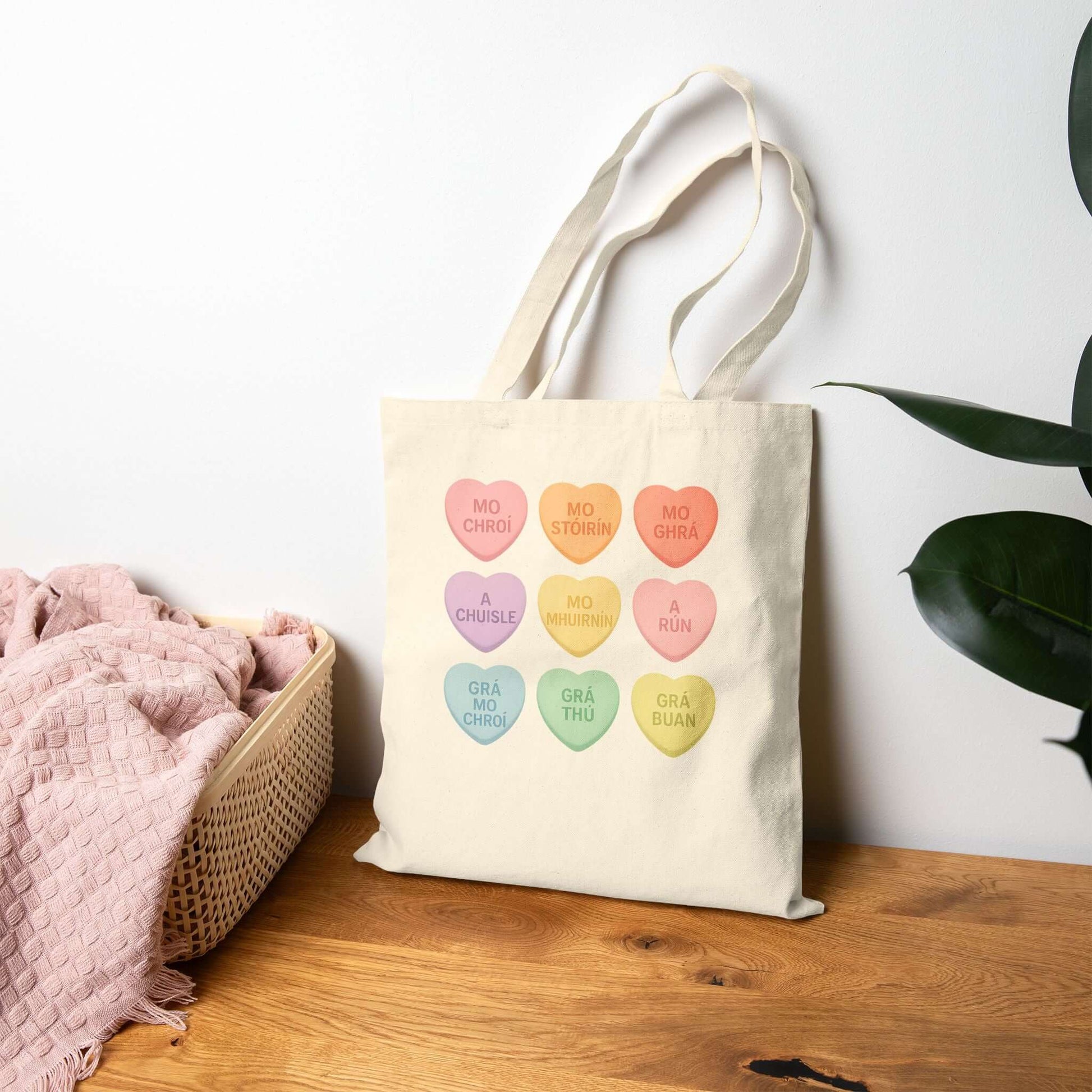 Gaelic conversation hearts tote bag on pink background

Irish love phrases canvas tote bag flat lay

Natural canvas tote with Gaelic Valentine hearts

Irish language tote bag with pastel hearts