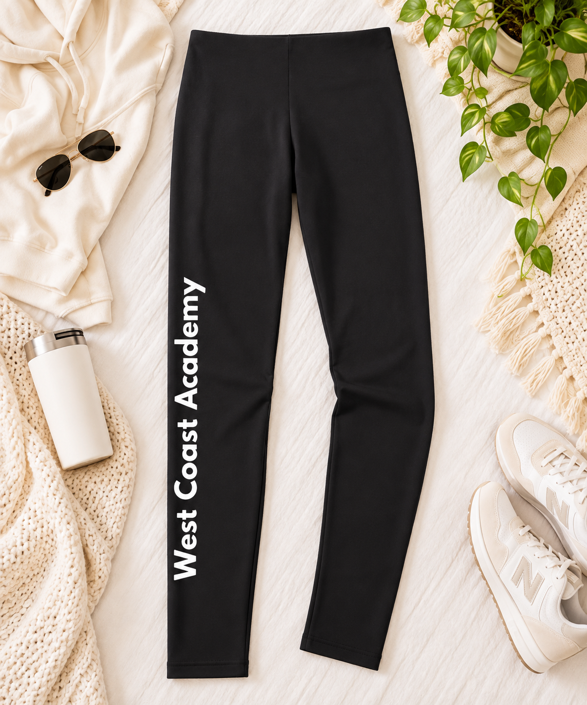 West Coast Academy black Irish dance leggings with West Coast Academy printed in white down the leg, flat lay